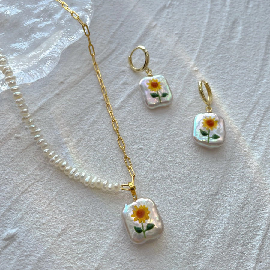 Sunflower Pearl Pendant, featuring pearls set in 18K gold-plated and terling silver chain, complemented by Sunflower Pearl Earrings.