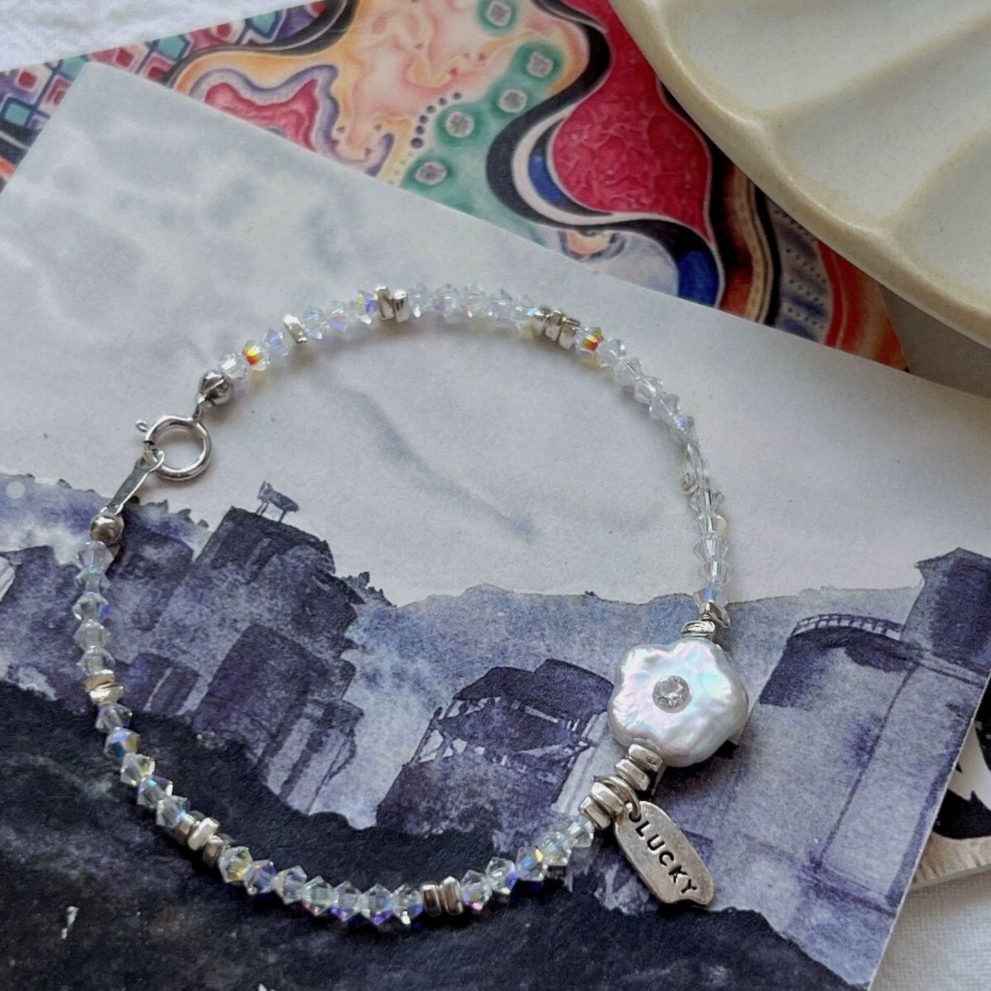 Charming Mother-of-Pearl Floral Charm Bracelet with Iridescent Beads and Pink Gemstone Accents