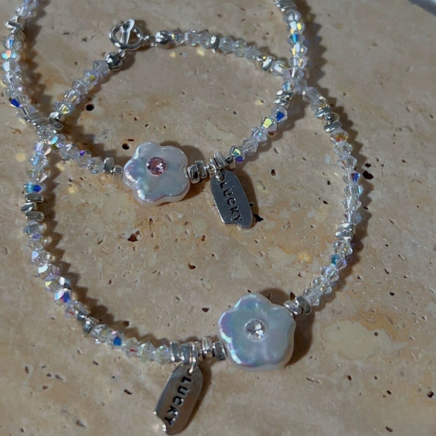 Charming Mother-of-Pearl Floral Charm Bracelet with Iridescent Beads and Pink Gemstone Accents