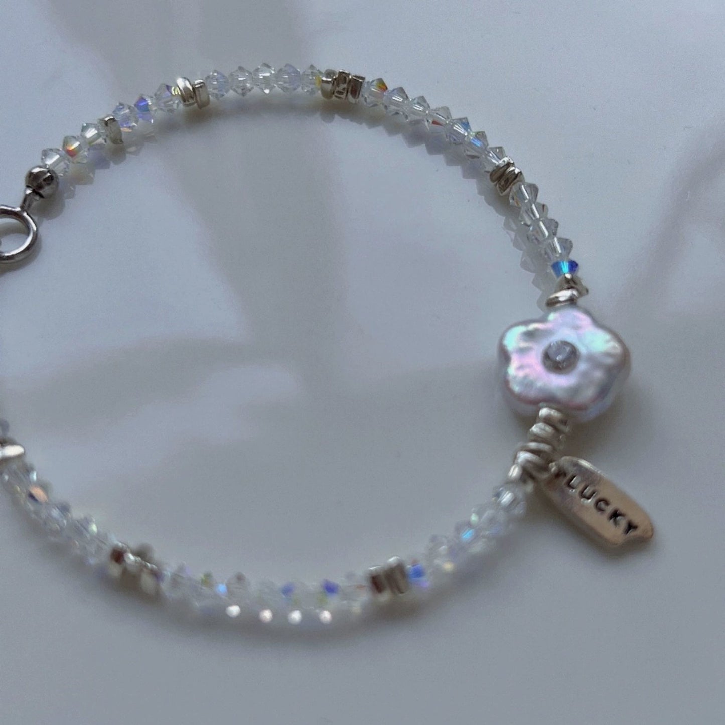 Charming Mother-of-Pearl Floral Charm Bracelet with Iridescent Beads and Pink Gemstone Accents