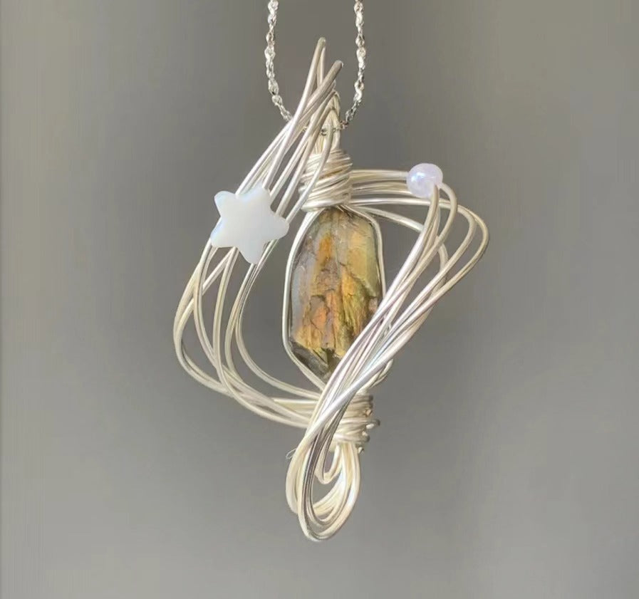 Unique Handcrafted Necklace with Star Accents, Gold Crystal Pendant, and Silver Chain Wound in the Shape of Neptune