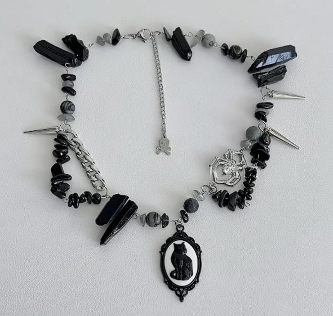 Cyberpunk black cat pendant silver choker, decorated with obsidian, accented with spider and spike elements, featuring a unique design.