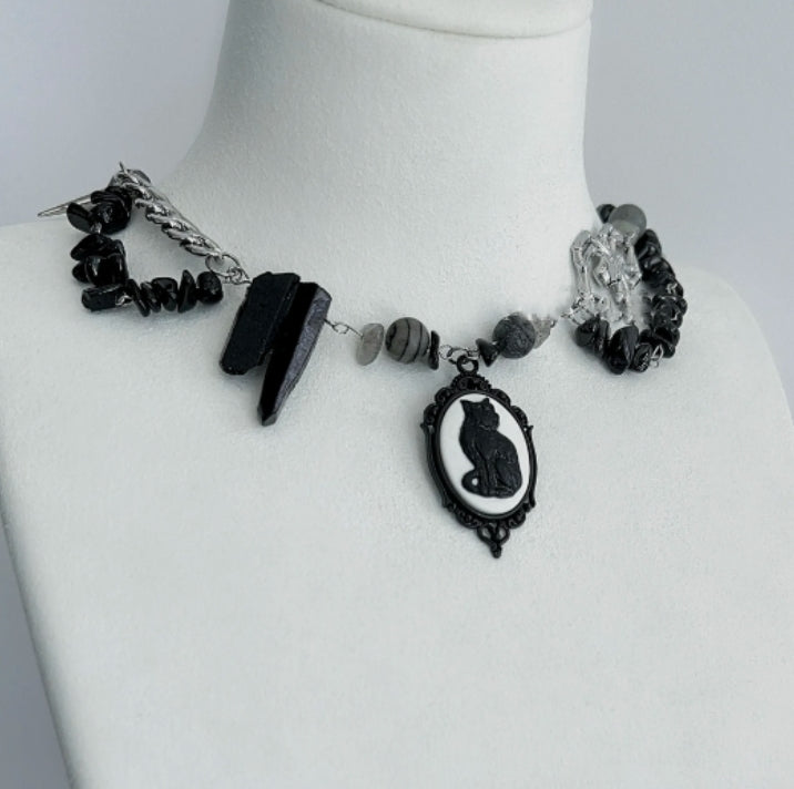Cyberpunk black cat pendant silver choker, decorated with obsidian, accented with spider and spike elements, featuring a unique design.