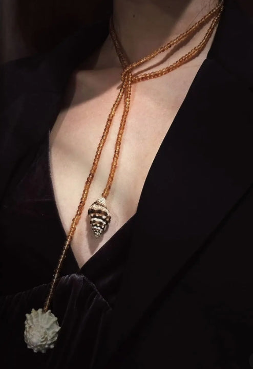 Handcrafted, conch and shells necklace, with amber-colored beads, versatile ways to wear it. The design is unique,makes for a perfect gift
