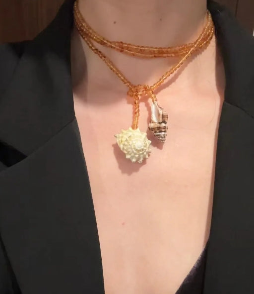 Handcrafted, conch and shells necklace, with amber-colored beads, versatile ways to wear it. The design is unique,makes for a perfect gift