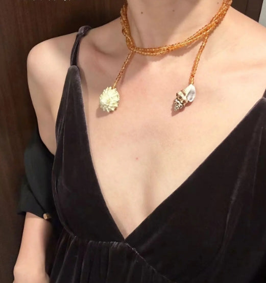 Handcrafted, conch and shells necklace, with amber-colored beads, versatile ways to wear it. The design is unique,makes for a perfect gift