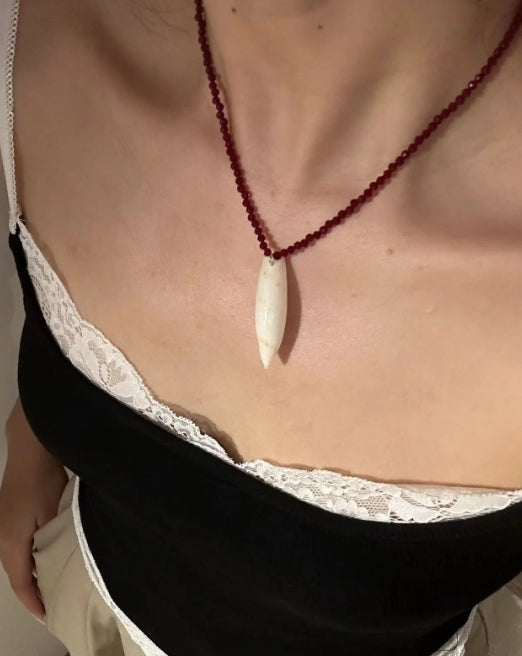 Handcrafted conch pendant with deep red beads necklace,natural conch shells, featuring a simple and exquisite design. It's a perfect gift.