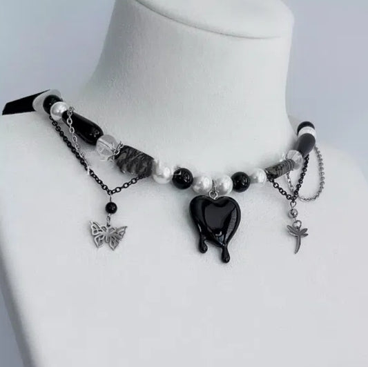 vintage-style black heart pendant necklace, adorned with butterfly and dragonfly motifs, decorated with obsidian and black crystal elements,  Y2K choker. It's a perfect gift