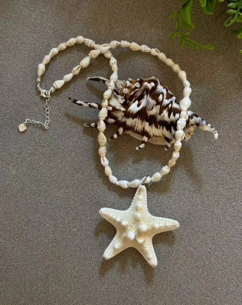 Handcrafted white starfish necklace, composed of small conch shells forming the chain, making it a one-of-a-kind piece. It's a perfect gift