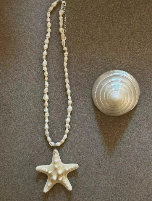 Handcrafted white starfish necklace, composed of small conch shells forming the chain, making it a one-of-a-kind piece. It's a perfect gift