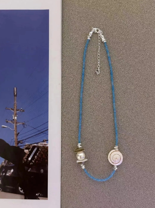 Handcrafted natural shell necklace, paired with a blue beaded strand, designed with a simple and elegant aesthetic,a thoughtful gift for her