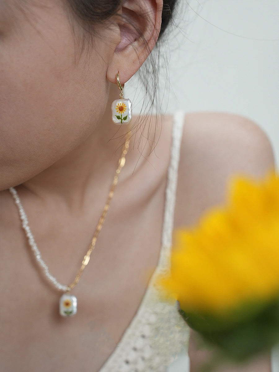 Sunflower Pearl Pendant, featuring pearls set in 18K gold-plated and terling silver chain, complemented by Sunflower Pearl Earrings.