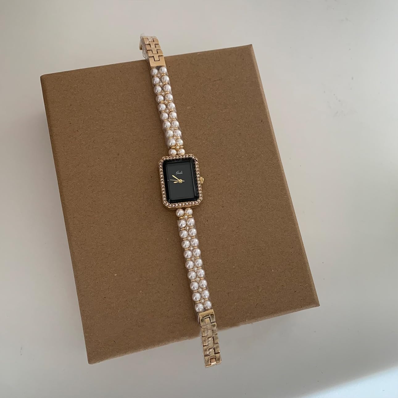 Pearl Strap Black Gold Watch: Square Dial for a Unique, Stylish Women's Timepiece with Sophisticated Appeal
