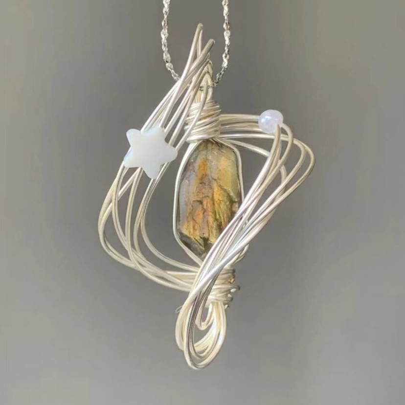 Unique Handcrafted Necklace with Star Accents, Gold Crystal Pendant, and Silver Chain Wound in the Shape of Neptune