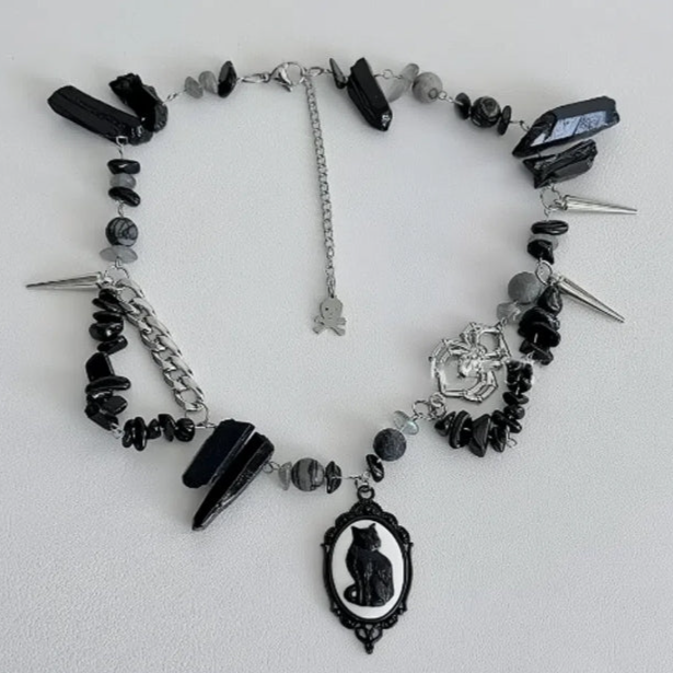 Cyberpunk black cat pendant silver choker, decorated with obsidian, accented with spider and spike elements, featuring a unique design.