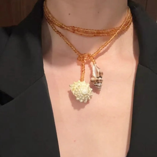 Handcrafted, conch and shells necklace, with amber-colored beads, versatile ways to wear it. The design is unique,makes for a perfect gift