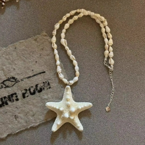 Handcrafted white starfish necklace, composed of small conch shells forming the chain, making it a one-of-a-kind piece. It's a perfect gift