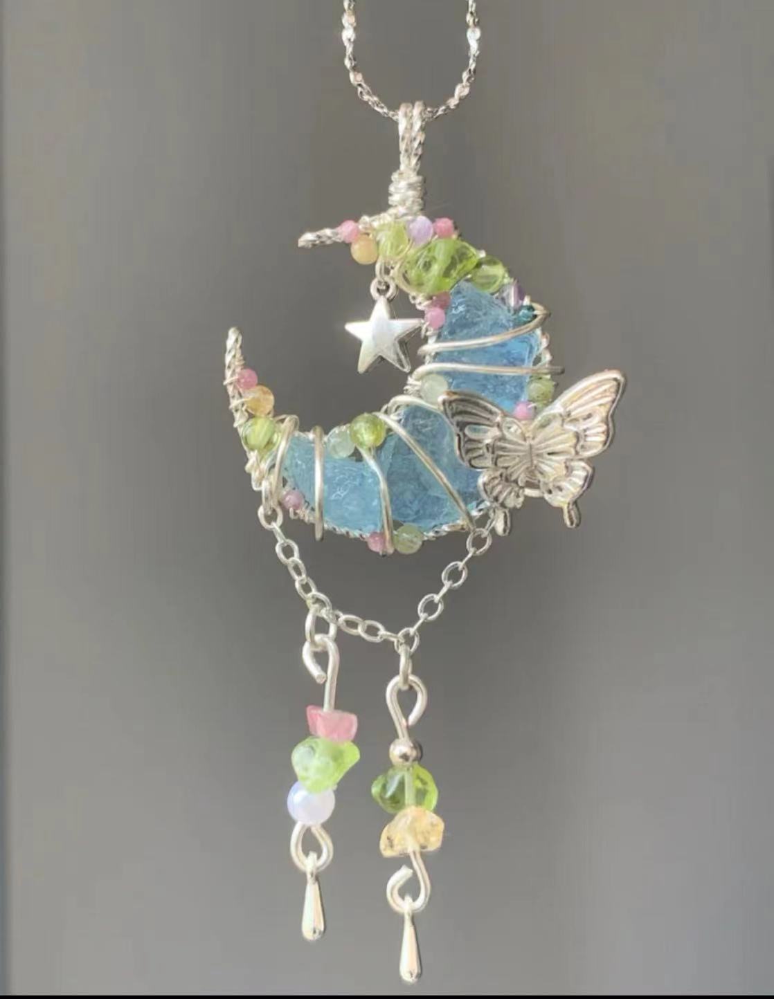 Moon-shaped blue crystal pendant necklace, adorned with butterfly and multicolored floral crystal elements, silver chain, unique handmade crystal necklace.