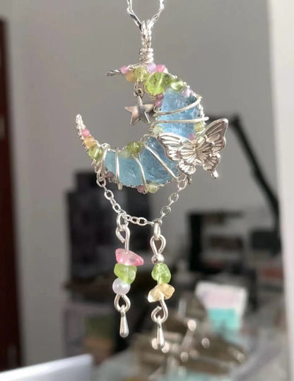 Moon-shaped blue crystal pendant necklace, adorned with butterfly and multicolored floral crystal elements, silver chain, unique handmade crystal necklace.