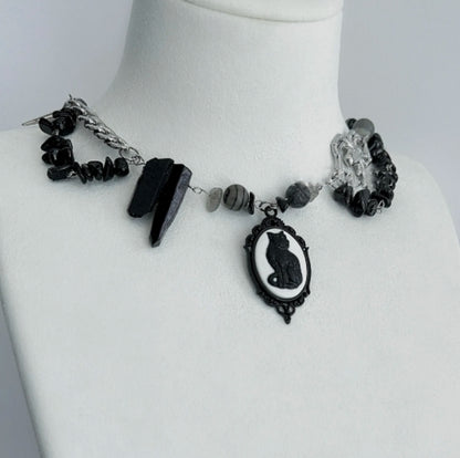 Cyberpunk black cat pendant silver choker, decorated with obsidian,  accented with spider and spike elements, featuring a unique design.