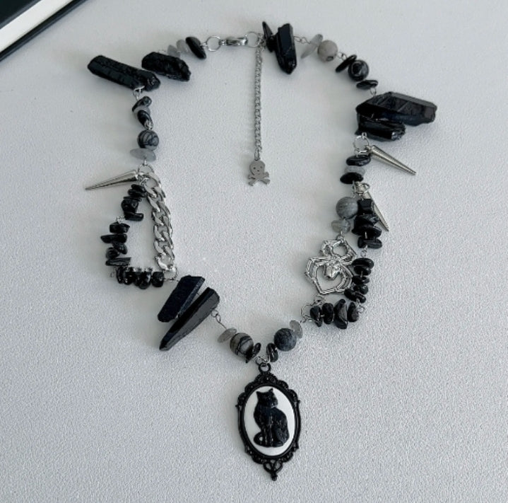 Cyberpunk black cat pendant silver choker, decorated with obsidian,  accented with spider and spike elements, featuring a unique design.