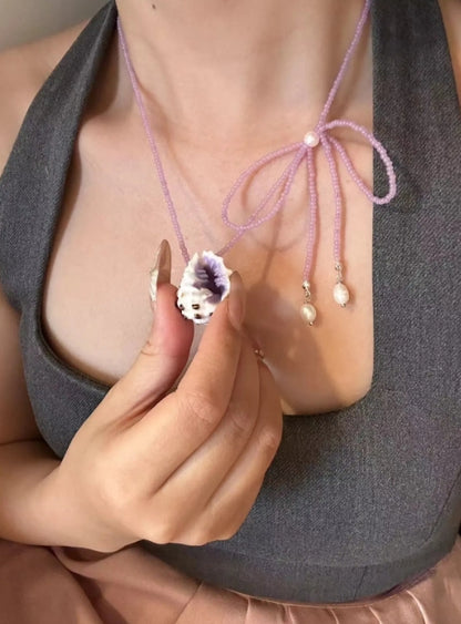 Handcrafted with natural purple conch shells, paired with a purple bow and purple beaded chain, unique and elegant aesthetic,a perfect gift