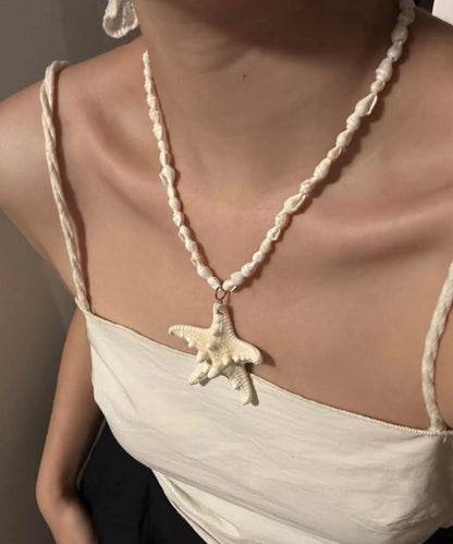 Handcrafted white starfish necklace, composed of small conch shells forming the chain, making it a one-of-a-kind piece. It's a perfect gift