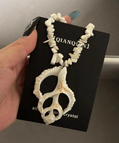 Handcrafted white conch pendant necklace, featuring an irregularly shaped conch, showcasing a unique marine element design,a perfect gift