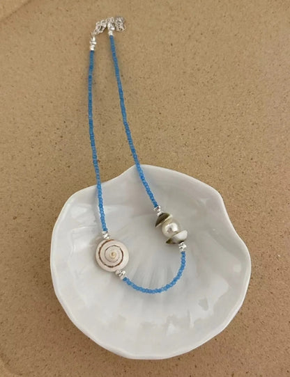 Handcrafted natural shell necklace, paired with a blue beaded strand, designed with a simple and elegant aesthetic,a thoughtful gift for her