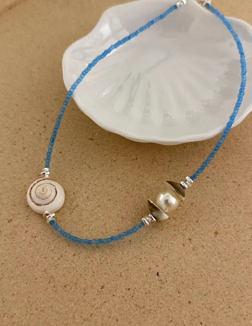 Handcrafted natural shell necklace, paired with a blue beaded strand, designed with a simple and elegant aesthetic,a thoughtful gift for her