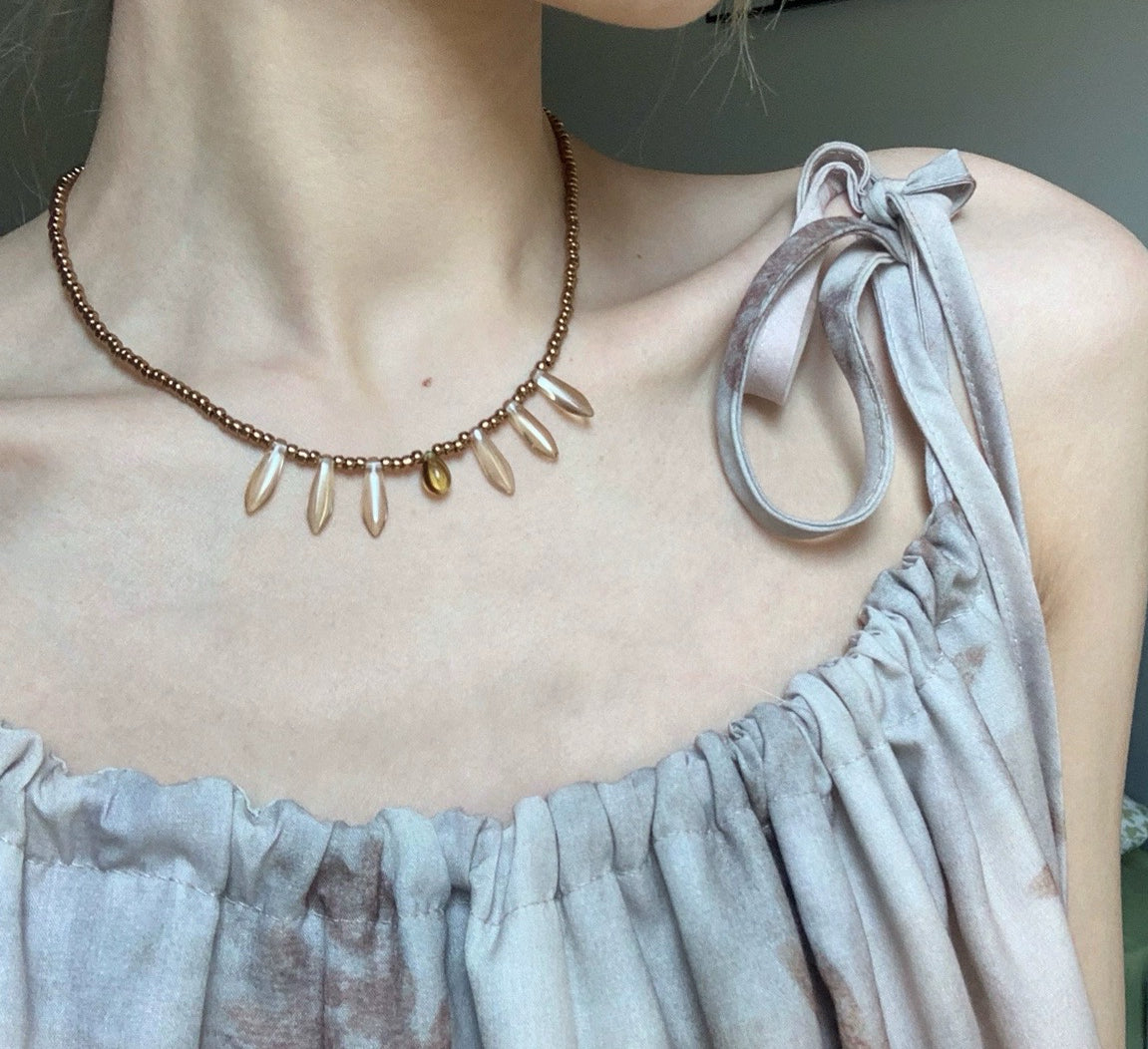 Vintage court-style necklace featuring Czech beads paired with natural stone transparent teardrop pendants.