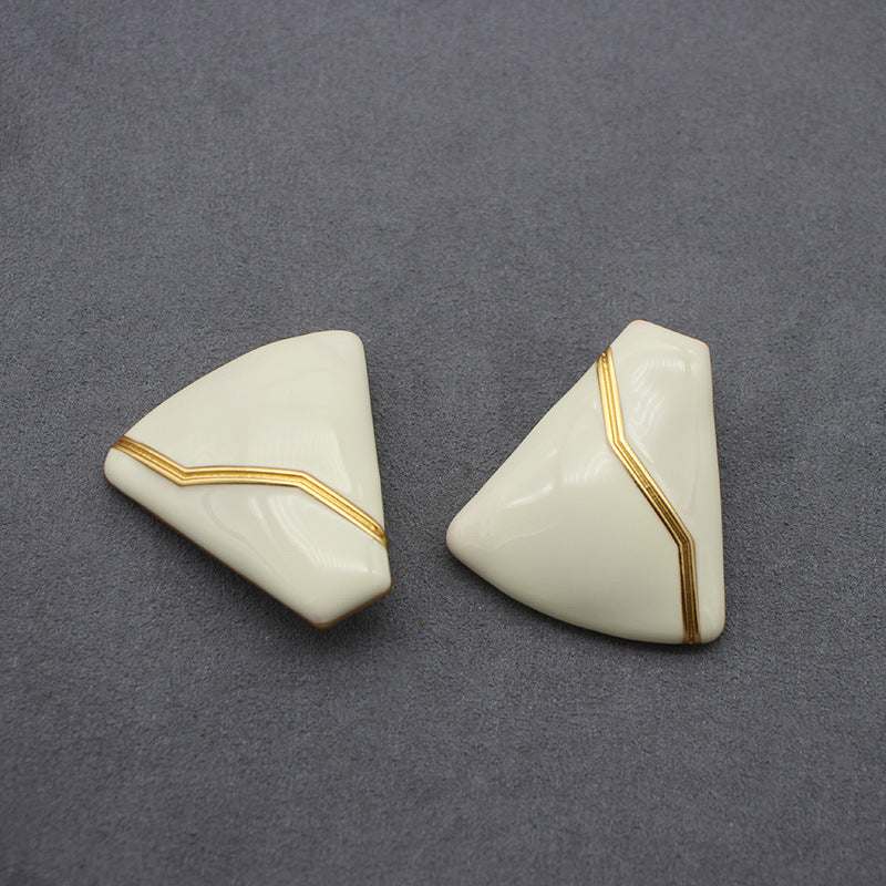 Sleek white enamel geometric earrings with gold zigzag pattern, modern electroplated geometric jewelry, chic accessory for everyday elegance and special occasions.
