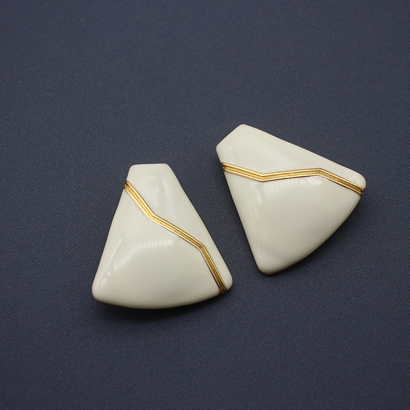 Sleek white enamel geometric earrings with gold zigzag pattern, modern electroplated geometric jewelry, chic accessory for everyday elegance and special occasions.