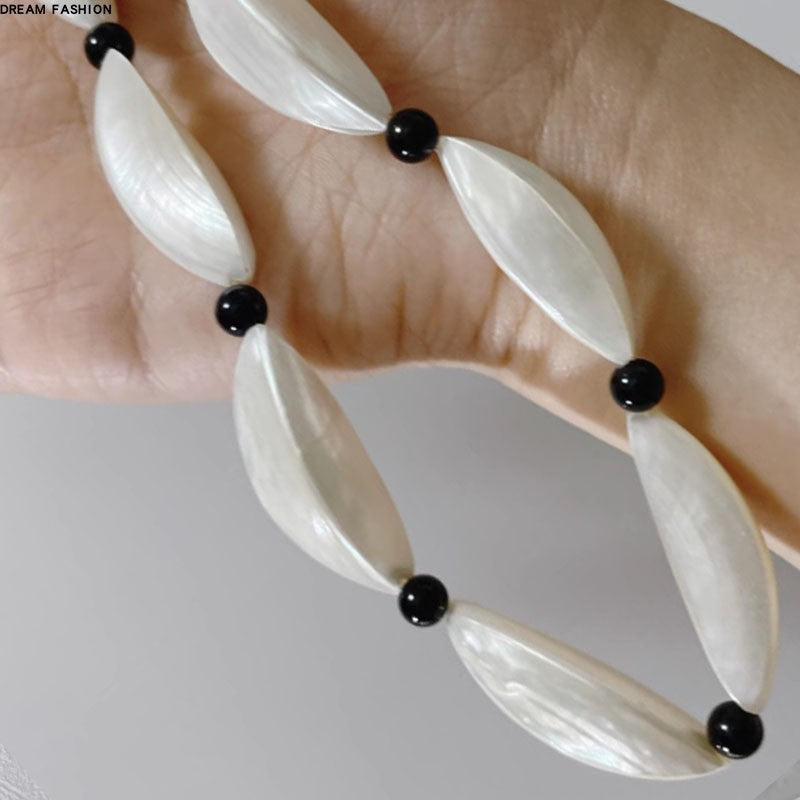 Crescent Moon White and Black Beaded Clavicle Chain Necklace with Statement Design
