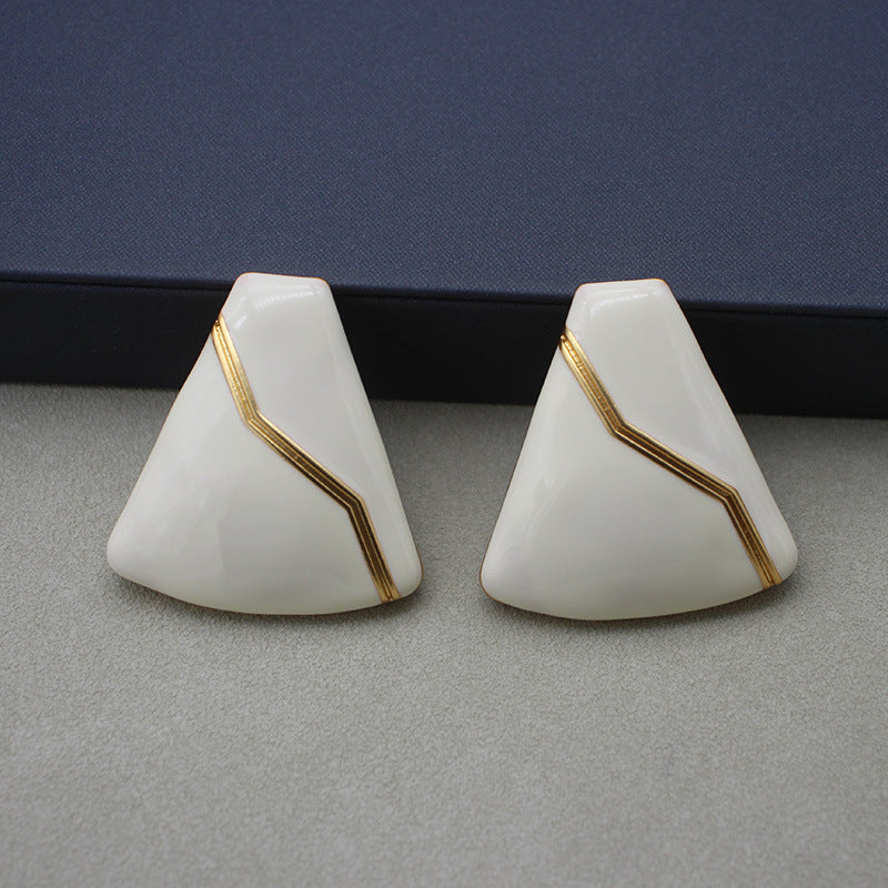 Sleek white enamel geometric earrings with gold zigzag pattern, modern electroplated geometric jewelry, chic accessory for everyday elegance and special occasions.
