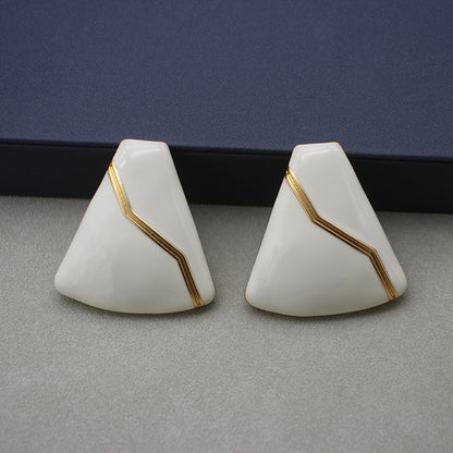 Sleek white enamel geometric earrings with gold zigzag pattern, modern electroplated geometric jewelry, chic accessory for everyday elegance and special occasions.