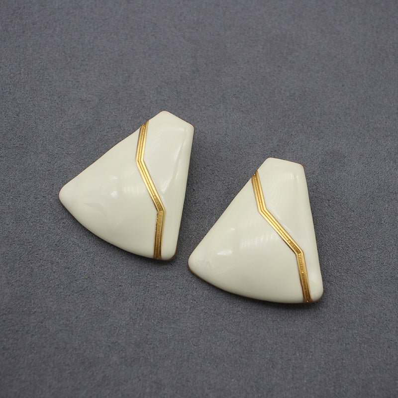 Sleek white enamel geometric earrings with gold zigzag pattern, modern electroplated geometric jewelry, chic accessory for everyday elegance and special occasions.
