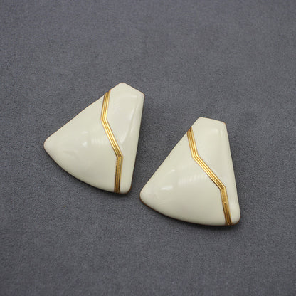 Sleek white enamel geometric earrings with gold zigzag pattern, modern electroplated geometric jewelry, chic accessory for everyday elegance and special occasions.